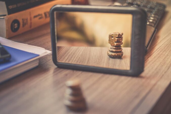 Black Frame Mirror on the Brown Wooden Table